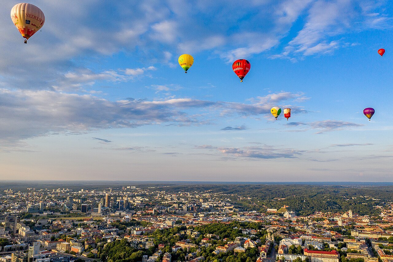 Hot-air balloons floating above Vilnius at golden hour