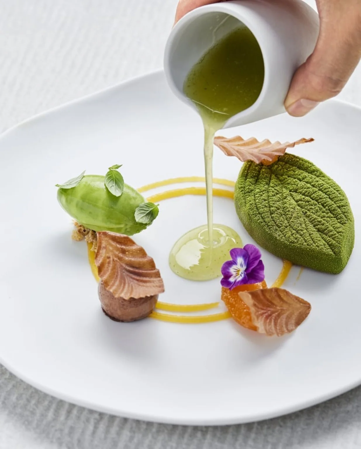 A dish being finished at Arrivée restaurant in Kaunas