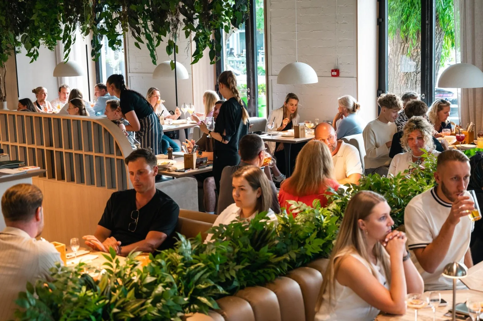Busy dining room at Paslėpti receptai in Kaunas
