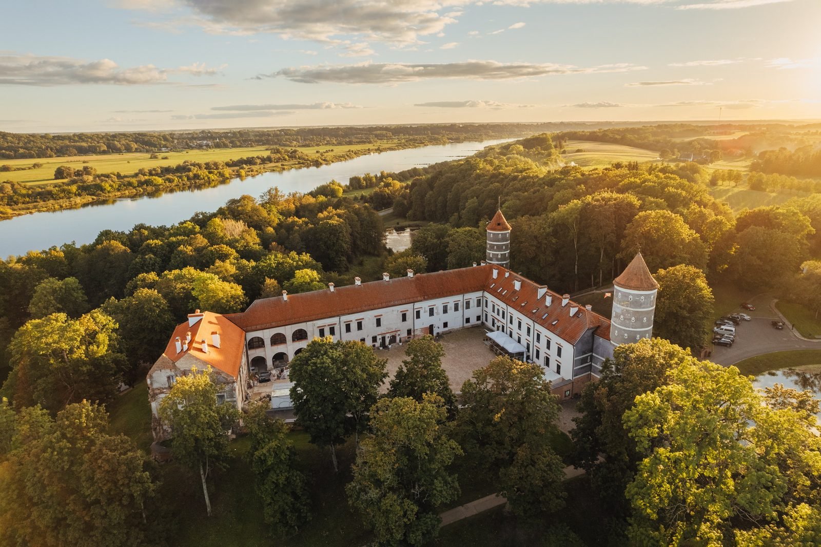 Panemunė Castle beside the Nemunas River in warm evening light, photographed from above in 2025