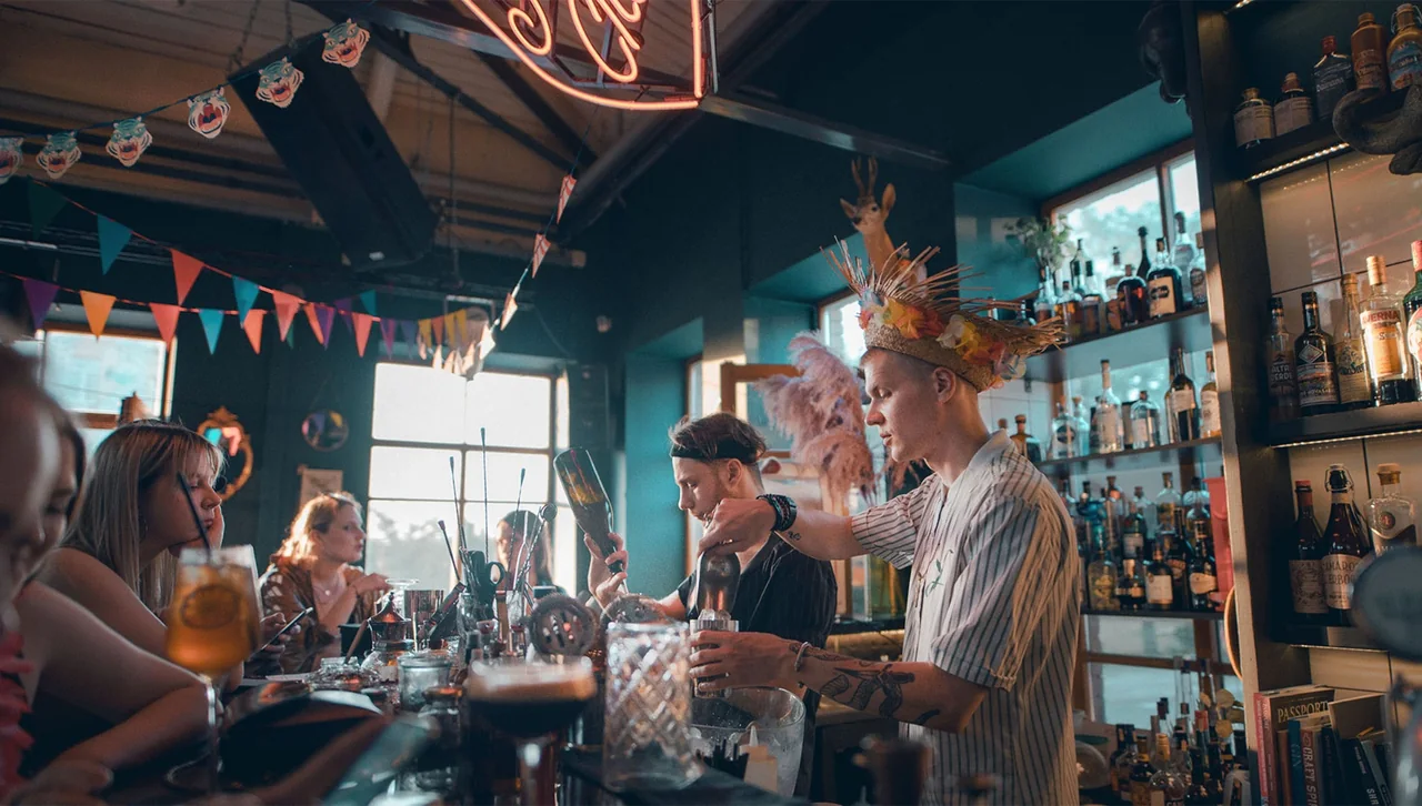 Bartenders making cocktails in a busy Vilnius bar