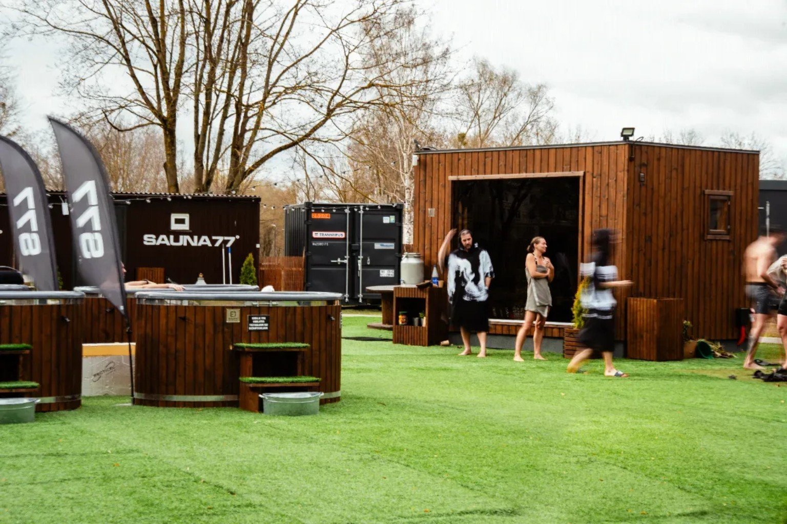 S77° Kaunas outdoor sauna area with wooden cabins and cold-water plunge tubs